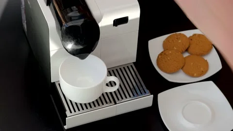 View of hand loading capsule  in coffee machine and brewing cup of coffee. Stock Footage 132400618