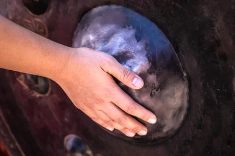 View of hand touch and scrub at the gong or temple big round bell or Thai tra Stock Photos