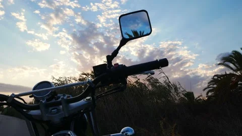 View from the handlebar of a motorcycle, windy and cloudy at sunset Video stock 139540306