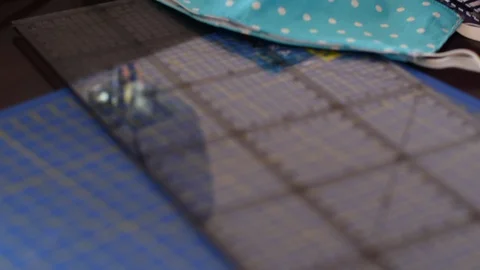View on handmade fabric cotton face masks on a table with sewing accessories. Stock Footage 128208046