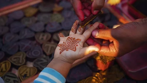 View of hands applying henna to a child's palm, Bangladesh. Stock Footage 335015715