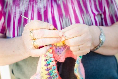 View of Hands close-up of an old lady knitting on knitting needles Stock Photos