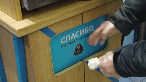 View of hands of man in disposable gloves throwing garbage into trash can indoor Stock Footage 151100813