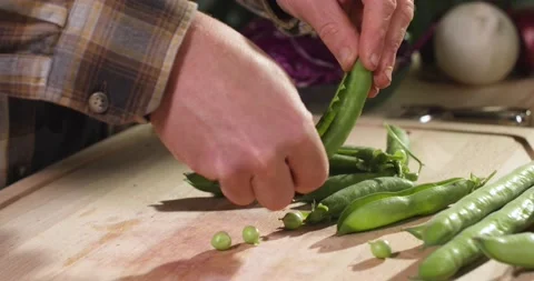 View of hands peeling fresh broad beans from their pods. Stock Footage 154849472