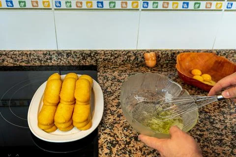 View of hands preparing the cream to make a Tiramisu cake in the kitchen at h Stock Photos