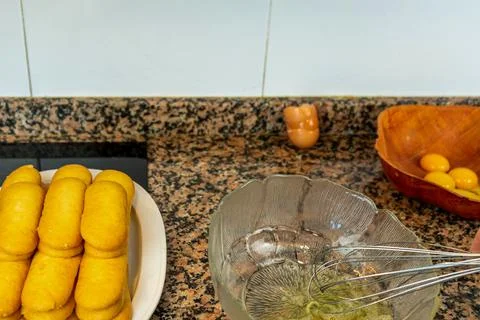 View of hands preparing the cream to make a Tiramisu cake in the kitchen at h Stock Photos