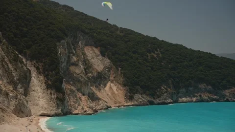 View of hang glider over turquoise sea and Myrtos Beach, Kefalonia (Cephalonia), Stock Footage 252621926