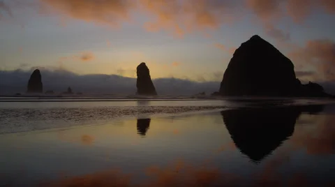 View of Haystack rock at sunset on Canno... | Stock Video | Pond5