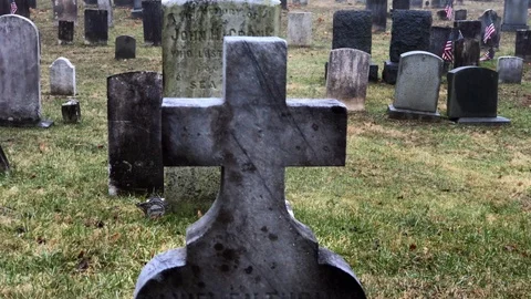 View of Headstones in Old Cemetery with Large Cross Tombstone in Foreground Stock Footage 101308958