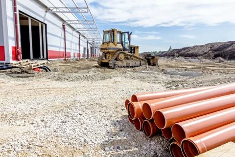 View on heavy bulldozer while he moving, leveling ground at construction site Stock Photos