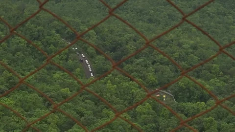 View of heavy traffic moving along a winding mountain road. Stock Footage 342047479