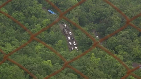 View of heavy traffic moving along a winding mountain road. 스톡 동영상 342047500