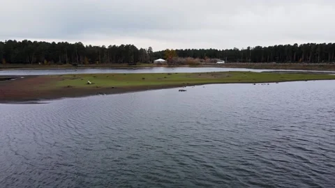 View from a height above the river, where cars pass in cloudy weather 스톡 동영상 168756307