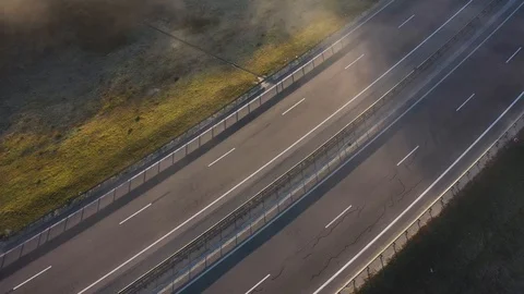 View from the height of the empty road. The road is shrouded in fog Stock Footage 99714046