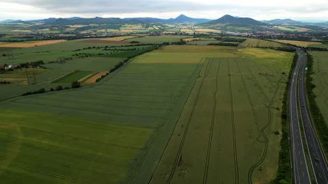 View from a height of the fields near the road on which cars drive. Stock Footage 233545988