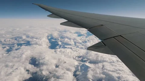 View From Height Of Flying Plane On Wing And Snow Capped Mountains Video stock 235319519