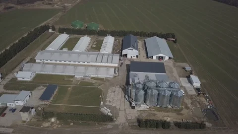 The view from the height of a large farm located among the green hilly fields Stock Footage 105146019