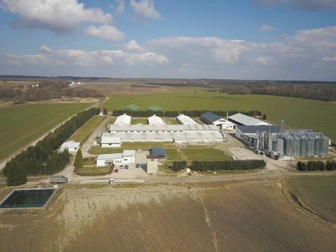 The view from the height of a large farm located among the green hilly fields Stock Photos