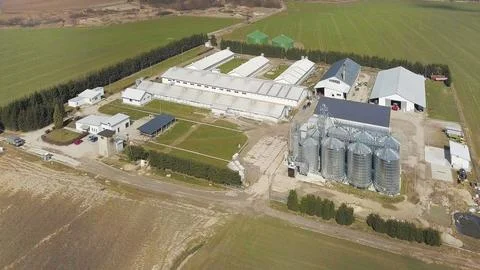 The view from the height of a large farm located among the green hilly fields Stock Photos