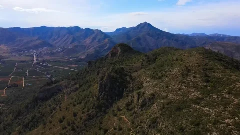 View from a height of a mountain peak. Valley and mountains in the background Stock Footage 241516262