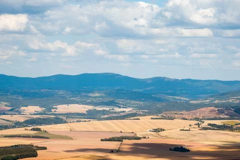 View from the height of a mountain range and many wheat fields, rural landsca Stock Photos