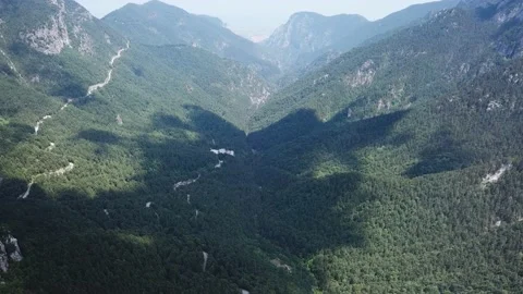 View from a height of a mountain valley with a forest Stock Footage 237986747