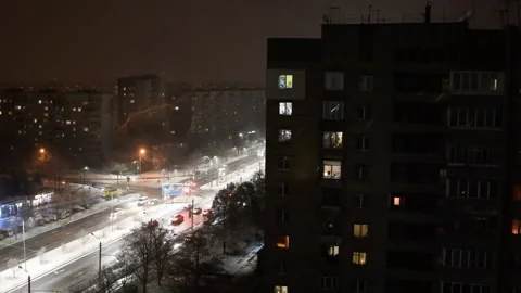 View from the height of the night city in winter, snow falls. Concept Video stock 144284017