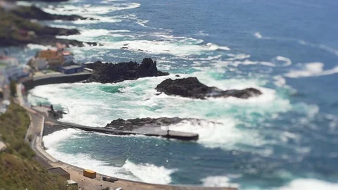 View from the height of the ocean and a small Spanish fishing town. Tilt Shift Stock Footage 115763725