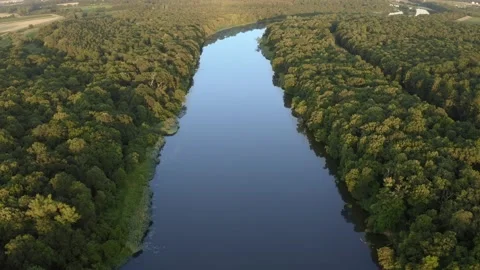 View from a height of a picturesque meandering river at sunset Stock Footage 225664032
