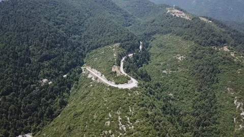 View from a height to a road serpentine on a mountainside Stock Footage 237986969