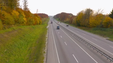 View from the height of the traffic on the road surrounded by autumn forest Stock Footage 119028926