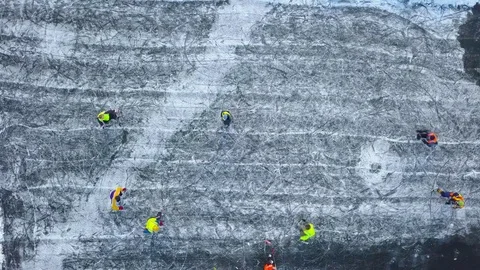 View from the height on unrecognizable people playing hockey in the winter Video stock 85128060