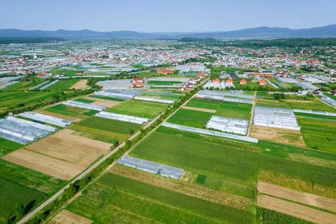 View from a height of the village, which has many greenhouses and fields. Stock Photos