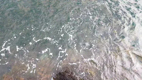 View from a height on the waves of the sea or ocean and rocks. Stock Footage 233591847