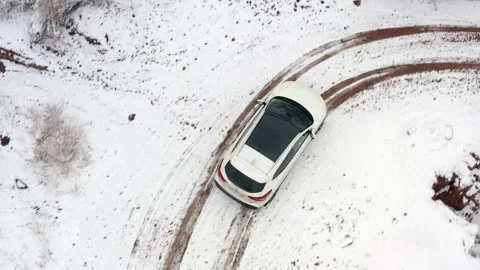 View from a height of a white SUV driving along a road Stock Footage 269097858