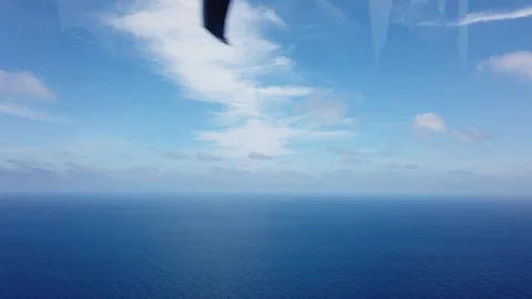 View from a helicopter cabin flying over sea. Stock Footage 102637017