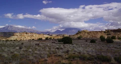 View of Henry Mountains over mesas and canyons near Capitol Reef NP Stock Footage 85452819