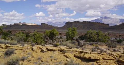 View of Henry Mountains over mesas and canyons near Capitol Reef NP Stock Footage 85493356