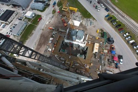 In this view from high above on the mobile launcher tower, a crane is used... Stock Photos