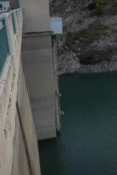 View from high angle of concrete wall and intake tower at Amadorio Dam abov.. Stock Photos