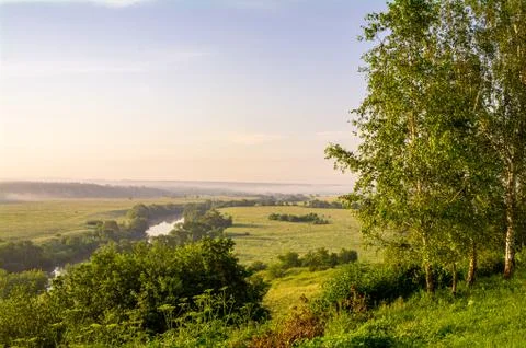 View from the high bank of the river on fields and forests Stock Photos