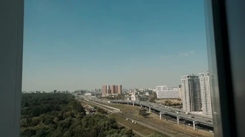 A view from a high-floor window of a city near a forest Stock Footage 309498257
