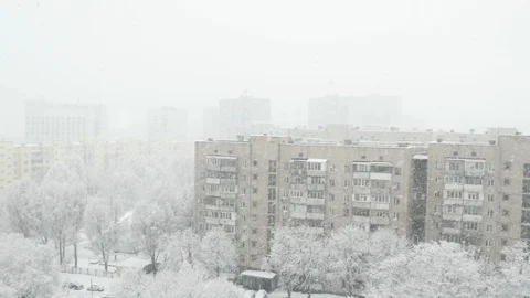 The view from a high floor at the winter town with falling snow. Stock Footage 103165777