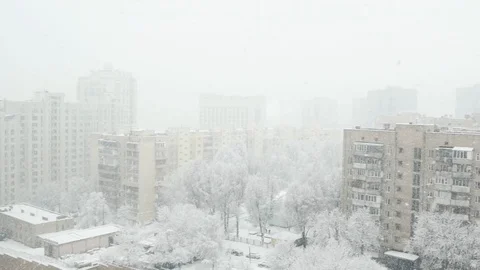 The view from a high floor at the winter town with falling snow. Stock Footage 103165781