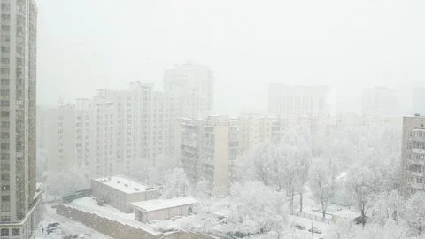 The view from a high floor at the winter town with falling snow. Stock Footage 103165787