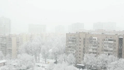 The view from a high floor at the winter town with falling snow. Stock Footage 103165798