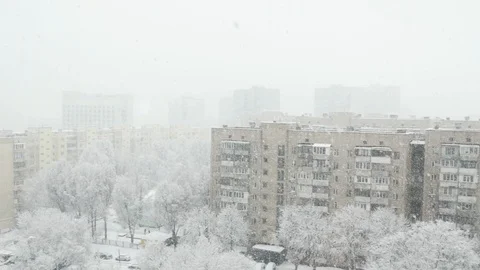 The view from a high floor at the winter town with falling snow. Stock Footage 115448585