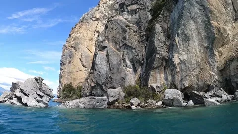View of a high marble cave cliff on General lake in Patagonia, turquoise water Stock Footage 130607951