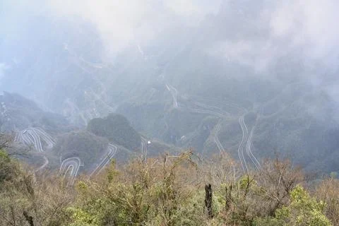 View from a high mountain on a loop road in fog in the Tianmenshan Mountain Stock Photos
