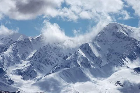 View of the high mountains on the cloudy sky background Stock Photos